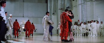 Movie still from “Armageddon” (1998), directed by Michael Bay – A group of people hugging each other in an indoor space; Wide shot, Low angle