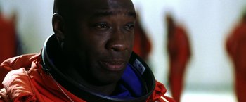 Movie still from “Armageddon” (1998), directed by Michael Bay – A person wearing a space suit; Close Up shot, Over the shoulder angle