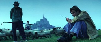 Movie still from “Armageddon” (1998), directed by Michael Bay – A herd of sheep walking across a lush green field; Wide shot, Low angle