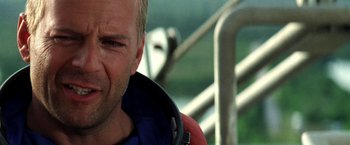 Movie still from “Armageddon” (1998), directed by Michael Bay – A man's face while sitting in a chair; Close Up shot, Over the shoulder angle