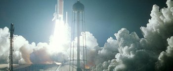 Movie still from “Armageddon” (1998), directed by Michael Bay – A rocket is launching into the sky with smoke coming from it; Extreme Wide shot, Low angle