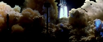 Movie still from “Armageddon” (1998), directed by Michael Bay – An image of a rocket launch in the clouds; Extreme Wide shot, Low angle
