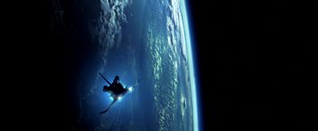 Movie still from “Armageddon” (1998), directed by Michael Bay – A person in a space suit skiing in front of the earth; Extreme Wide shot, Overhead angle