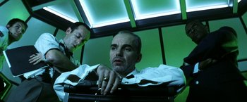 Movie still from “Armageddon” (1998), directed by Michael Bay – A man in a white dress shirt and a man in a green tie; Medium shot, Low angle