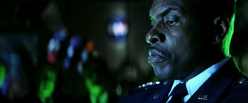 Movie still from “Armageddon” (1998), directed by Michael Bay – A man's face in a dark room; Close Up shot, Low angle