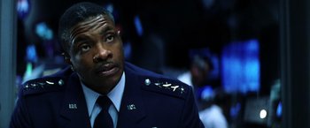 Movie still from “Armageddon” (1998), directed by Michael Bay – A person wearing a military uniform; Close Up shot, Low angle