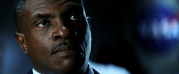 Movie still from “Armageddon” (1998), directed by Michael Bay – A man's face in the dark; Close Up shot, Low angle