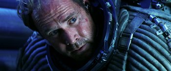 Movie still from “Armageddon” (1998), directed by Michael Bay – A person wearing a space suit; Close Up shot, Overhead angle