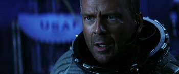 Movie still from “Armageddon” (1998), directed by Michael Bay – A person wearing a space suit; Close Up shot, Low angle