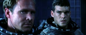 Movie still from “Armageddon” (1998), directed by Michael Bay – Two men in space suits looking at the camera; Close Up shot, Over the shoulder angle