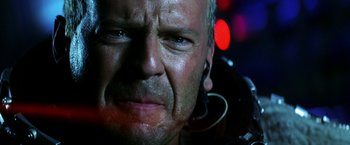 Movie still from “Armageddon” (1998), directed by Michael Bay – An older man wearing headphones and looking at the camera; Close Up shot, Low angle