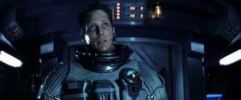 Movie still from “Armageddon” (1998), directed by Michael Bay – A man in a space suit is in a space ship; Close Up shot, Low angle