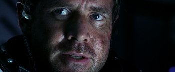 Movie still from “Armageddon” (1998), directed by Michael Bay – A man's face in the dark; Extreme Close Up shot, Over the shoulder angle