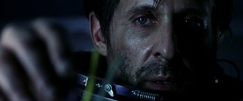 Movie still from “Armageddon” (1998), directed by Michael Bay – A man's face while wearing a metal neck brace; Close Up shot, Over the shoulder angle