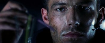 Movie still from “Armageddon” (1998), directed by Michael Bay – A man's face with dirt on his face; Close Up shot, Low angle