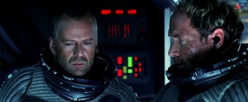 Movie still from “Armageddon” (1998), directed by Michael Bay – Two men in space suits in front of a control panel; Close Up shot, Over the shoulder angle