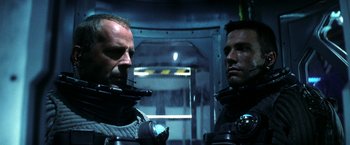 Movie still from “Armageddon” (1998), directed by Michael Bay – Two men in space suits are looking at each other; Close Up shot, Low angle