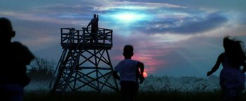 Movie still from “Armageddon” (1998), directed by Michael Bay – Two people standing on top of a wooden tower; Wide shot, Low angle