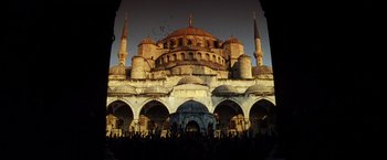 Movie still from “Armageddon” (1998), directed by Michael Bay – A group of people standing in front of a large building; Extreme Wide shot, Low angle
