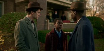 Movie still from “Fargo” (2014), created by Noah Hawley – A group of men standing next to each other on a field; Medium shot, Over the shoulder angle