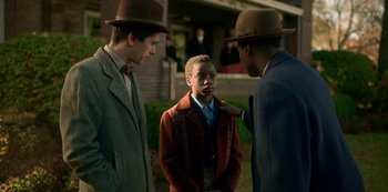 Movie still from “Fargo” (2014), created by Noah Hawley – A group of men standing next to each other wearing hats; Medium shot, Over the shoulder angle