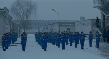 A large group of people standing in the middle of a snowy field