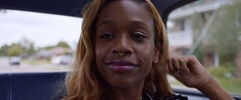 Movie still from “Assassination Nation” (2018), directed by Sam Levinson – A person with a piercing on her nose; Close Up shot, High angle