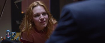 Movie still from “Assassination Nation” (2018), directed by Sam Levinson – A woman sitting in front of a mirror looking at the camera; Close Up shot, Over the shoulder angle