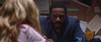 Movie still from “Assassination Nation” (2018), directed by Sam Levinson – A man in a suit looking at a woman in a dress shirt; Close Up shot, Over the shoulder angle