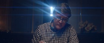 Movie still from “Assassination Nation” (2018), directed by Sam Levinson – A man with glasses is sitting in front of a window; Close Up shot, Over the shoulder angle