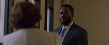 Movie still from “Assassination Nation” (2018), directed by Sam Levinson – A man wearing a suit and tie looking at a woman; Close Up shot, Over the shoulder angle