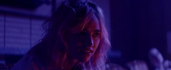 Movie still from “Assassination Nation” (2018), directed by Sam Levinson – A person with long blonde hair; Close Up shot, Over the shoulder angle