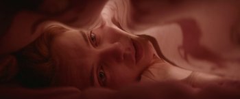 Movie still from “Assassination Nation” (2018), directed by Sam Levinson – A person laying in a bed; Extreme Close Up shot, Overhead angle