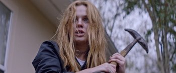 Movie still from “Assassination Nation” (2018), directed by Sam Levinson – A woman with blonde hair holding a baseball bat; Close Up shot, Low angle