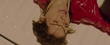 Movie still from “Assassination Nation” (2018), directed by Sam Levinson – A young woman is tied up and hanging upside down; Close Up shot, Overhead angle