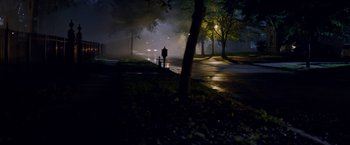 Movie still from “Assassination Nation” (2018), directed by Sam Levinson – A street corner at night in the rain; Extreme Wide shot, High angle