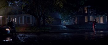 Movie still from “Assassination Nation” (2018), directed by Sam Levinson – A street with a tree and a building in the background; Extreme Wide shot, Low angle