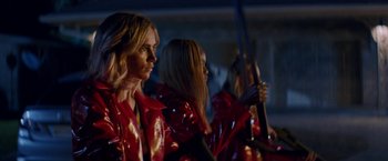 Movie still from “Assassination Nation” (2018), directed by Sam Levinson – A group of women in red jackets holding a pole; Medium shot, Low angle