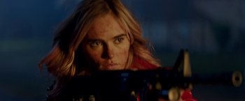 Movie still from “Assassination Nation” (2018), directed by Sam Levinson – A woman is looking into a mirror while holding a gun; Close Up shot, Over the shoulder angle