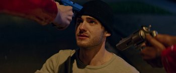 Movie still from “Assassination Nation” (2018), directed by Sam Levinson – A man getting his head shaved by a man with a gun; Close Up shot, Over the shoulder angle