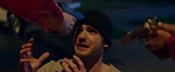 Movie still from “Assassination Nation” (2018), directed by Sam Levinson – A man is getting his head shaved by a barber; Close Up shot, Over the shoulder angle