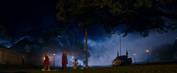 Movie still from “Assassination Nation” (2018), directed by Sam Levinson – Two people standing on the side of the road at night; Extreme Wide shot, High angle