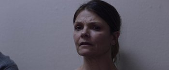 Movie still from “Assassination Nation” (2018), directed by Sam Levinson – A person looking at the camera; Close Up shot, Over the shoulder angle