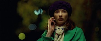 Movie still from “Attack the Block” (2011), directed by Joe Cornish – A woman in a purple hat is talking on a cell phone; Close Up shot, Low angle