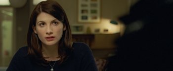 Movie still from “Attack the Block” (2011), directed by Joe Cornish – A person sitting in front of a lamp; Close Up shot, Over the shoulder angle