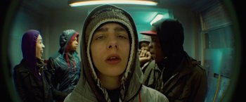 Movie still from “Attack the Block” (2011), directed by Joe Cornish – A young man in a hooded jacket is looking into the camera; Close Up shot, Low angle