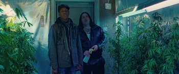 Movie still from “Attack the Block” (2011), directed by Joe Cornish – Two men standing next to each other holding a wii remote; Medium shot, Low angle
