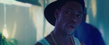 Movie still from “Attack the Block” (2011), directed by Joe Cornish – A person wearing a hat; Close Up shot, Over the shoulder angle