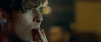 Movie still from “Attack the Block” (2011), directed by Joe Cornish – A person with a cigarette in his mouth; Extreme Close Up shot, Over the shoulder angle
