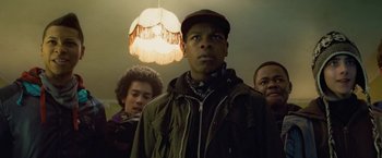 Movie still from “Attack the Block” (2011), directed by Joe Cornish – A group of people standing in front of a light; Close Up shot, Low angle